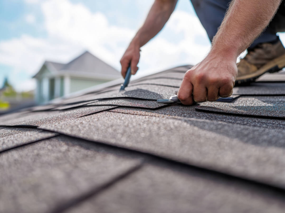 Roofer Inspecting Shingles for Hail Damage in Frisco Texas