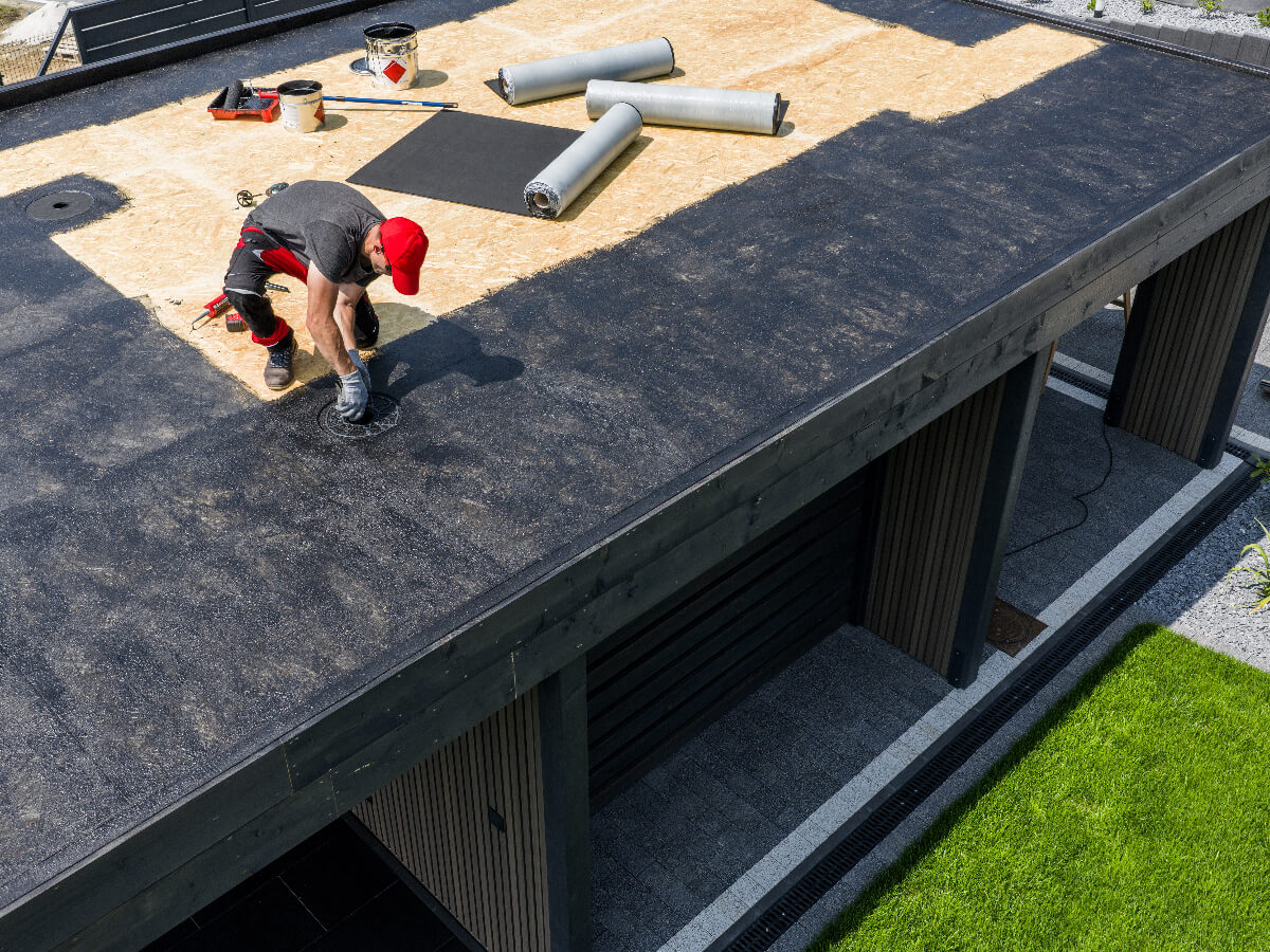 Roofer Installing EPDM Roof on Office Building in Frisco Texas
