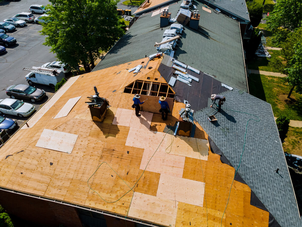 Roofers Replacing Asphalt Shingle Roofs in Apartment Community