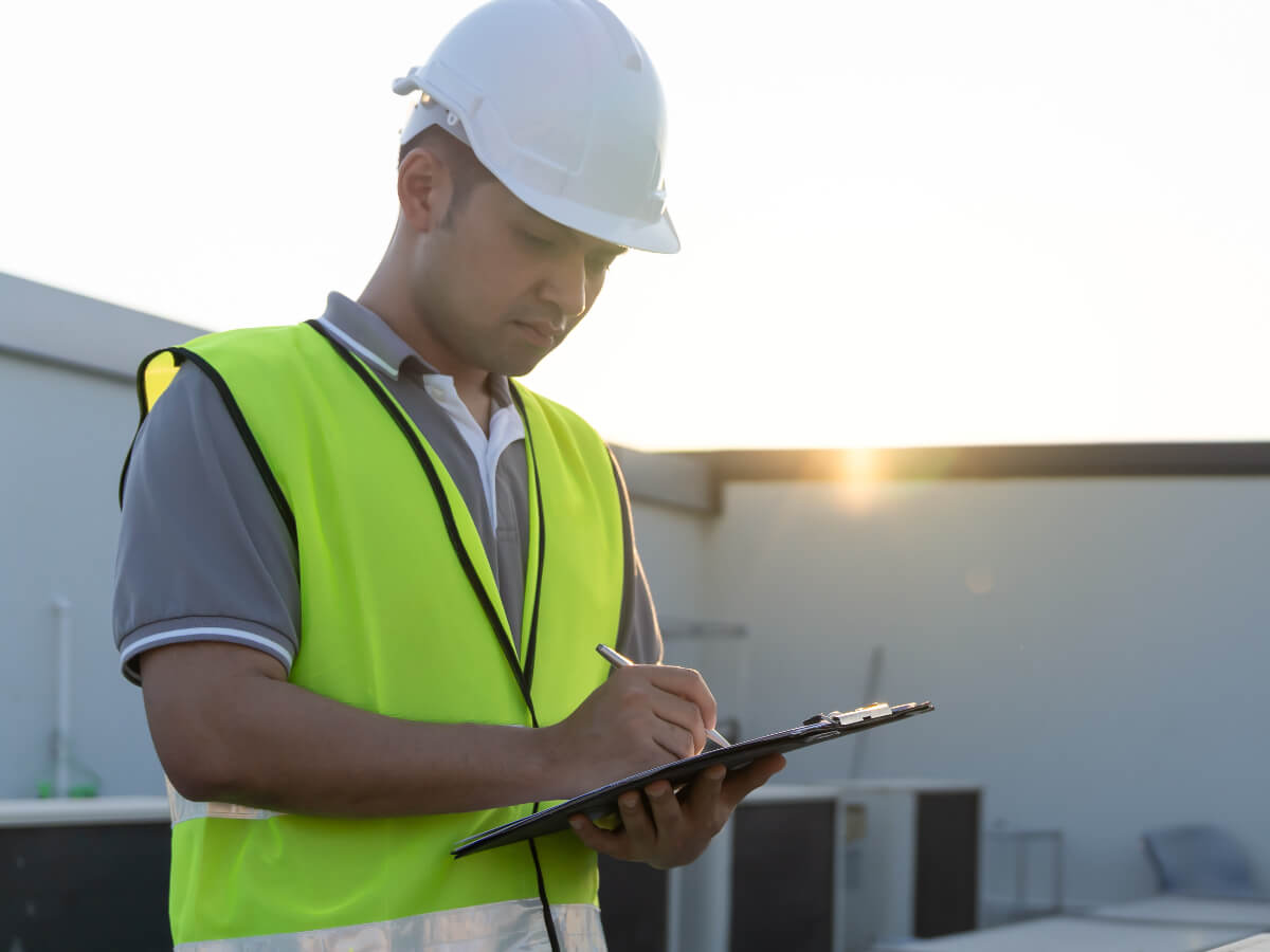 Roofer Analyzing Commercial Roof in Frisco Texas