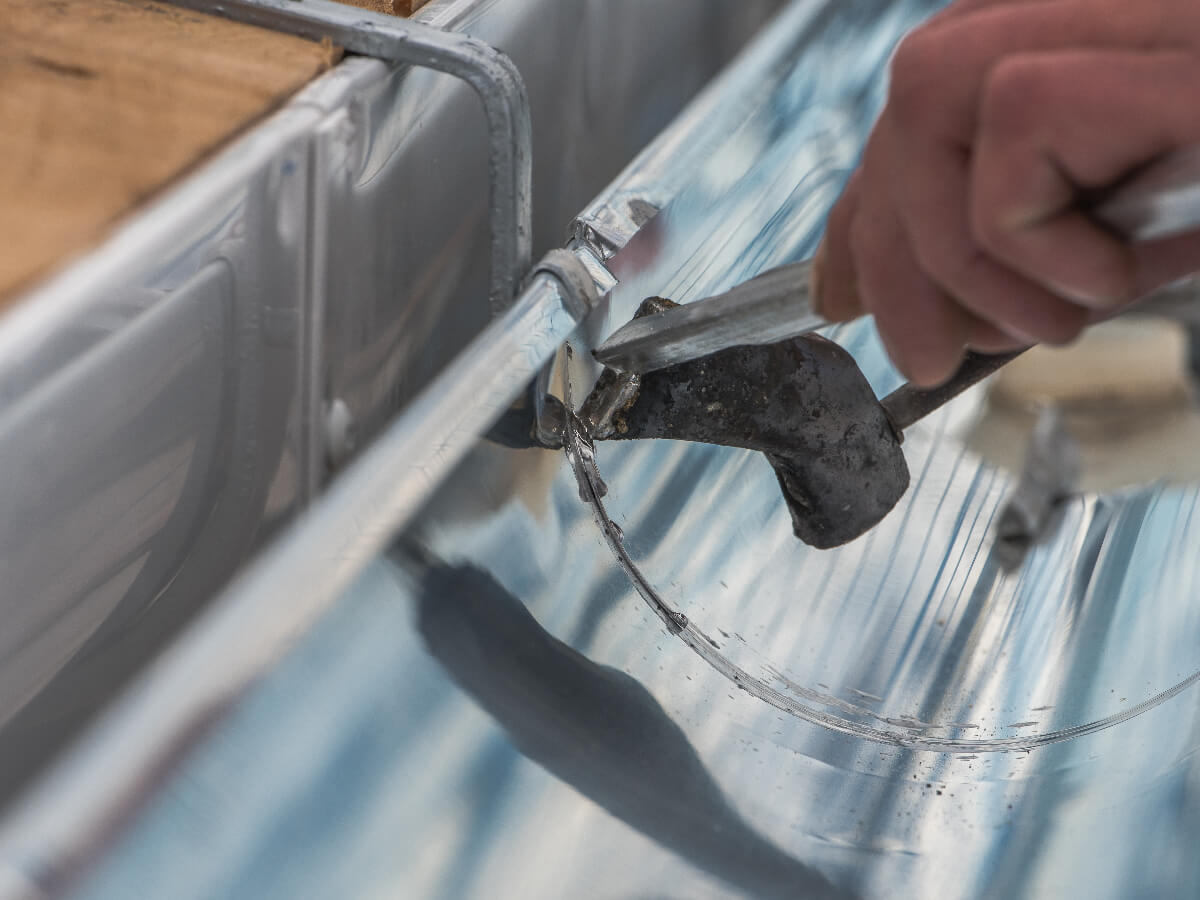 Roofer Installing New Gutters on Commercial Property in Frisco Texas