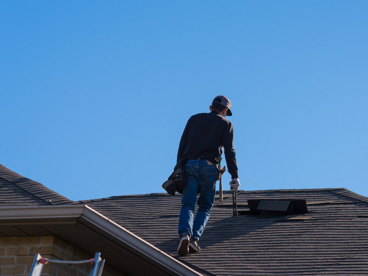 Roofer Inspecting Damaged Roof in Frisco Texas