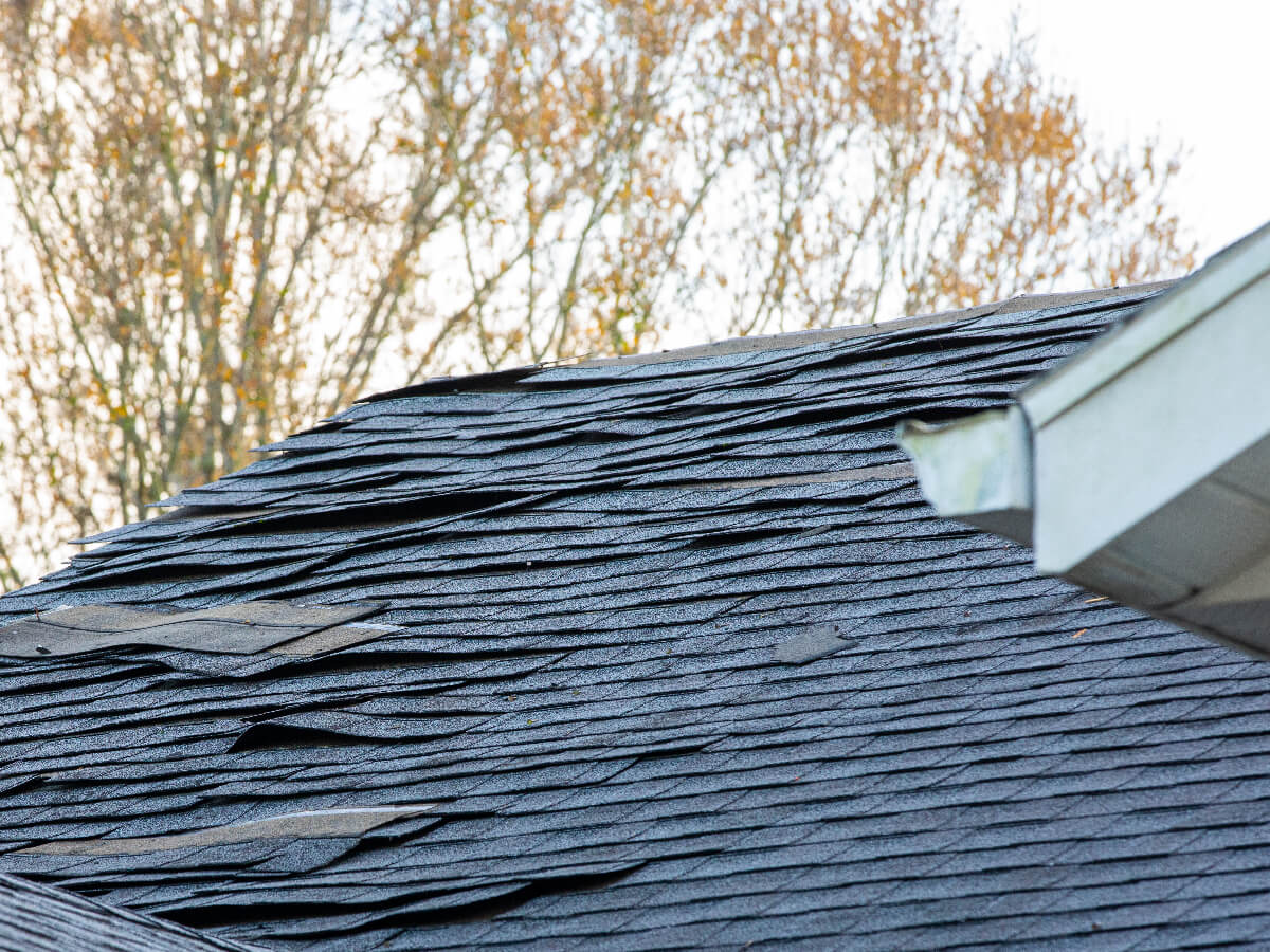 Roof with Damaged Shingles Following Major Storm in Frisco Texas